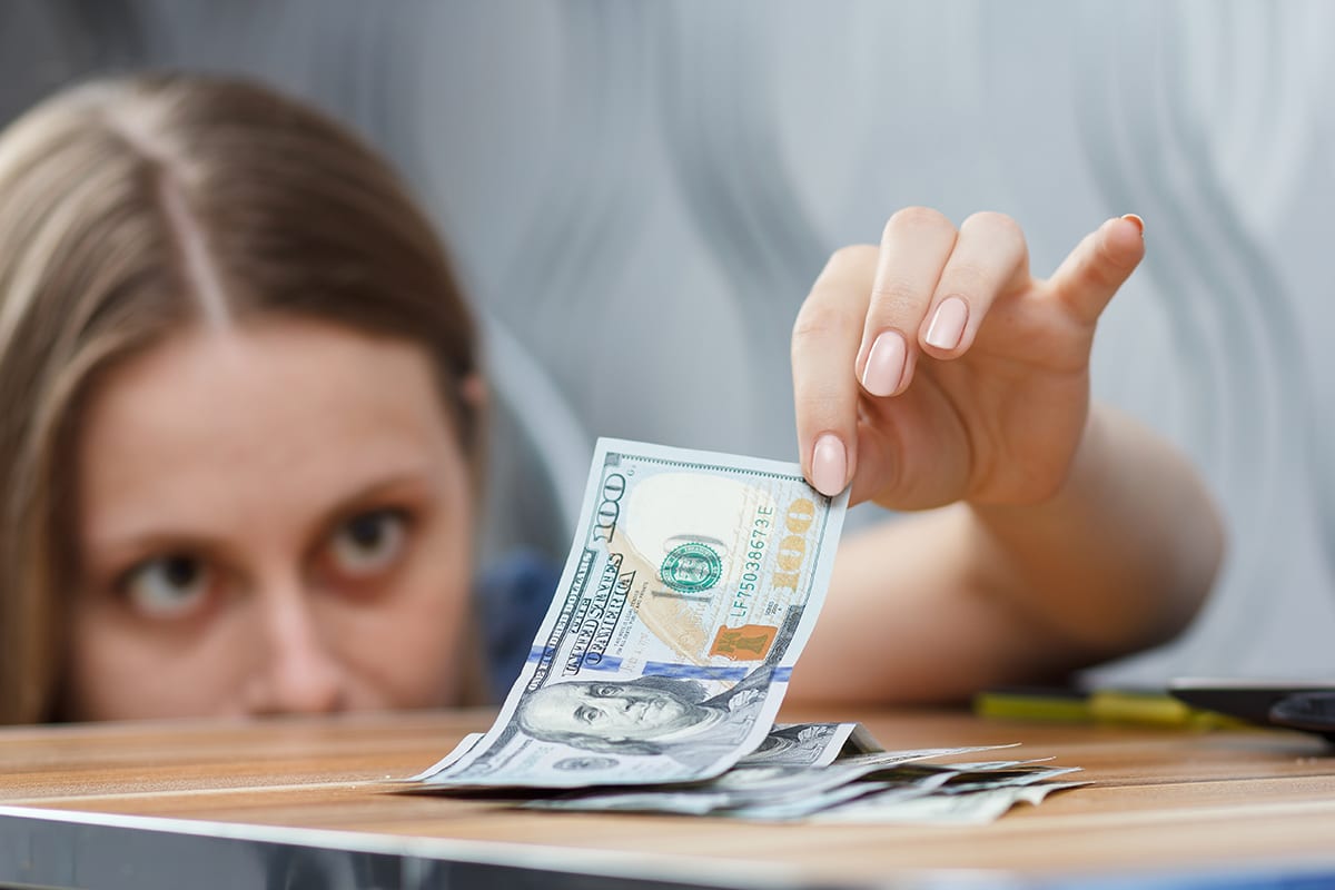 Woman Gently Picking Up Money