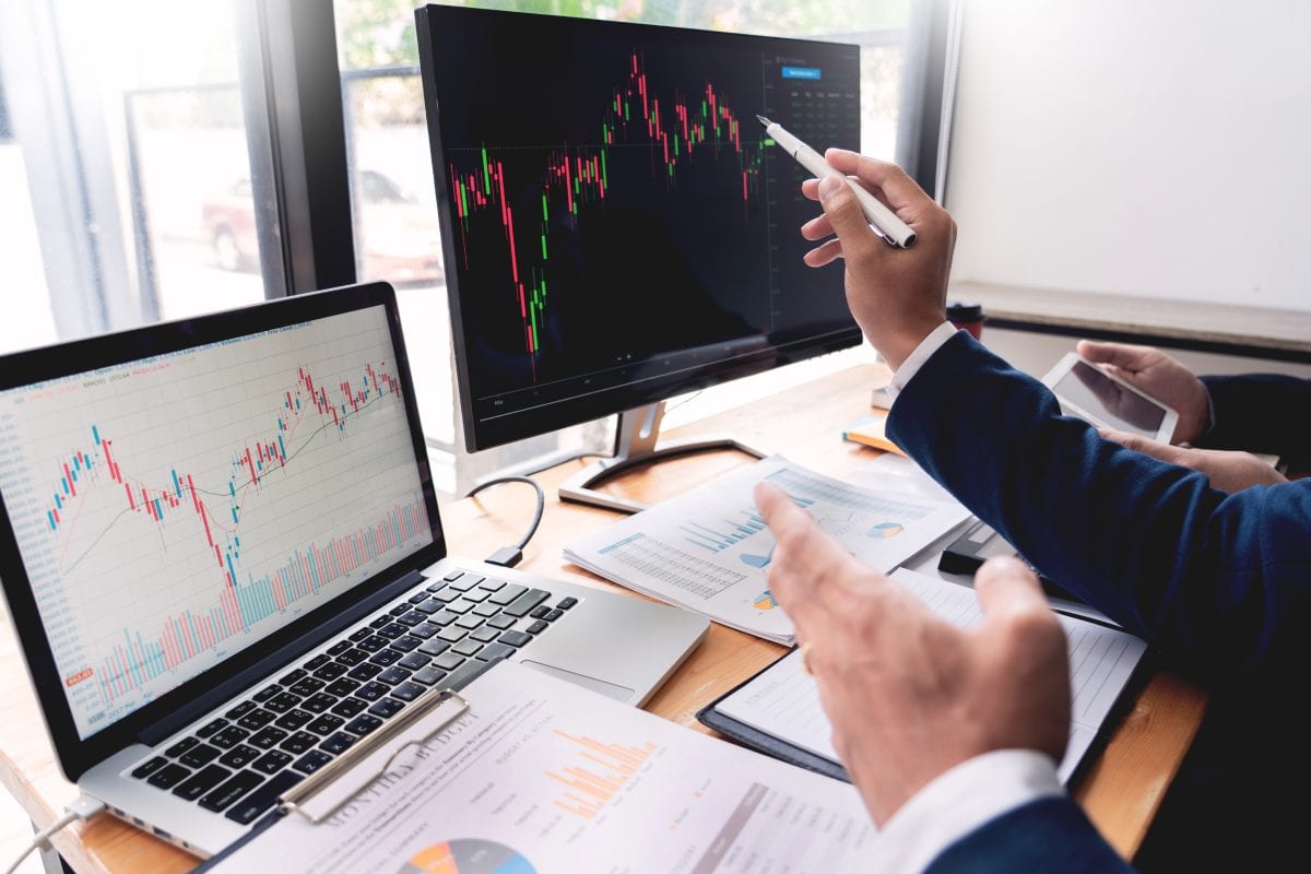 Man Looking at Stocks on Computer