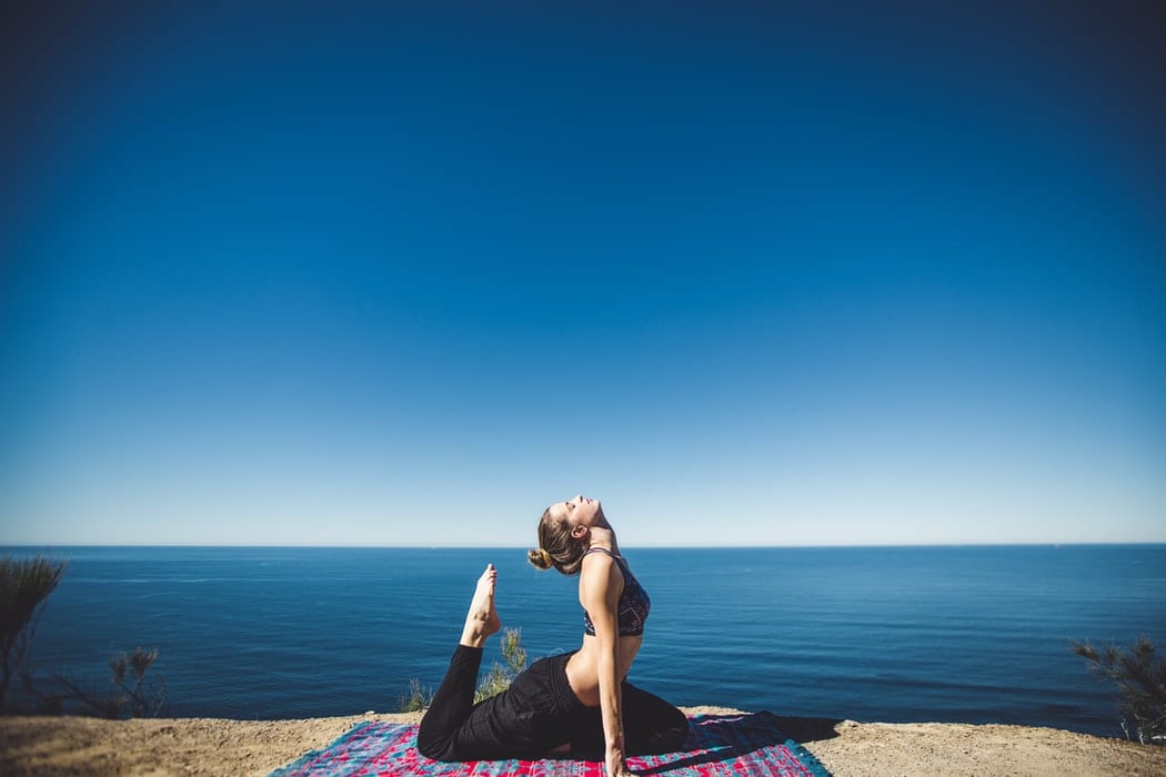 Woman Doing Yoga By The Beach
