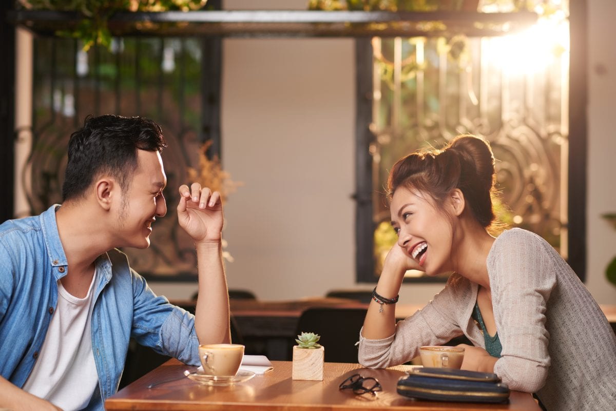 Couple Laughing at Coffee Shop