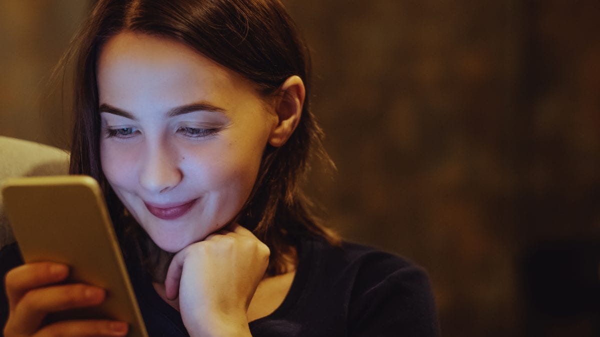 Young Woman Smiling at her Phone