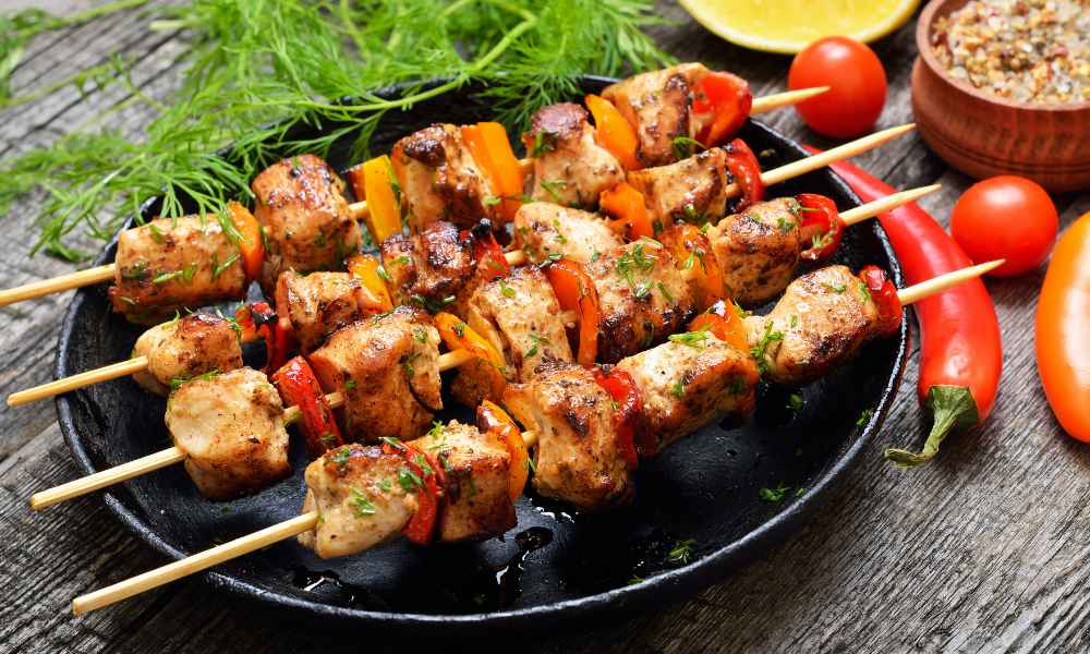 Chicken kebabs on grill.