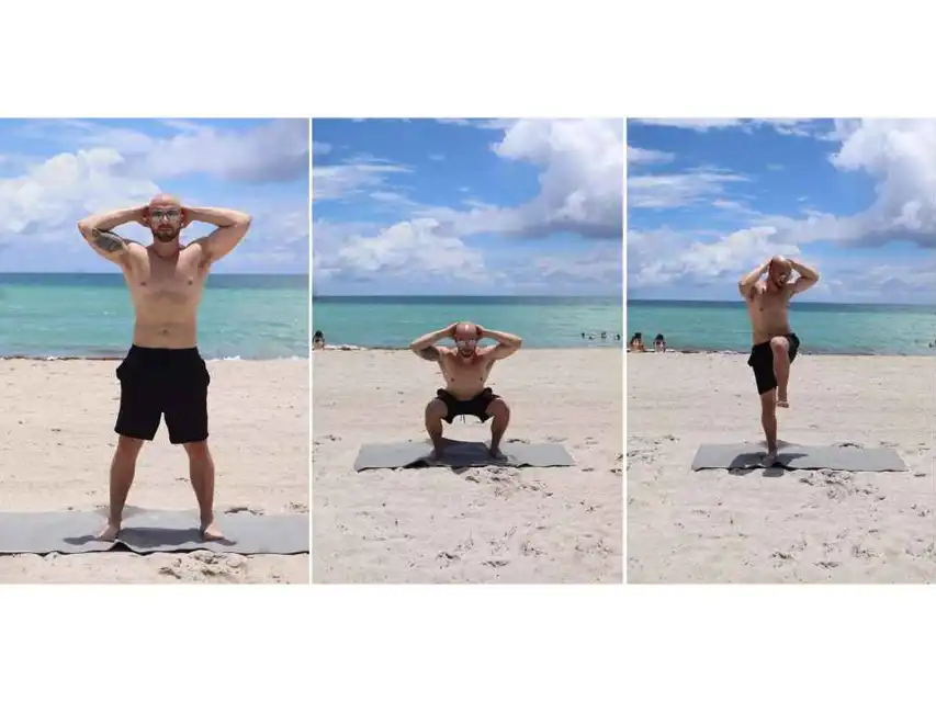 a man doing squats on a beach