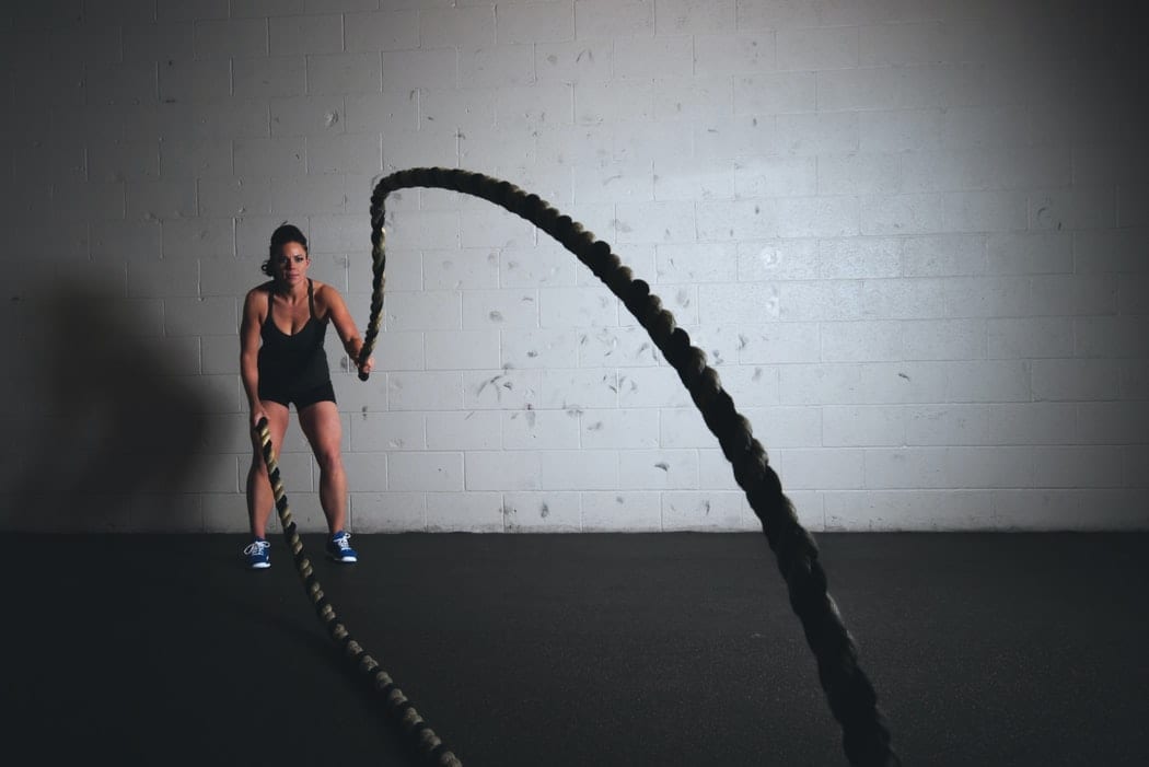 Woman Working out with battle ropes