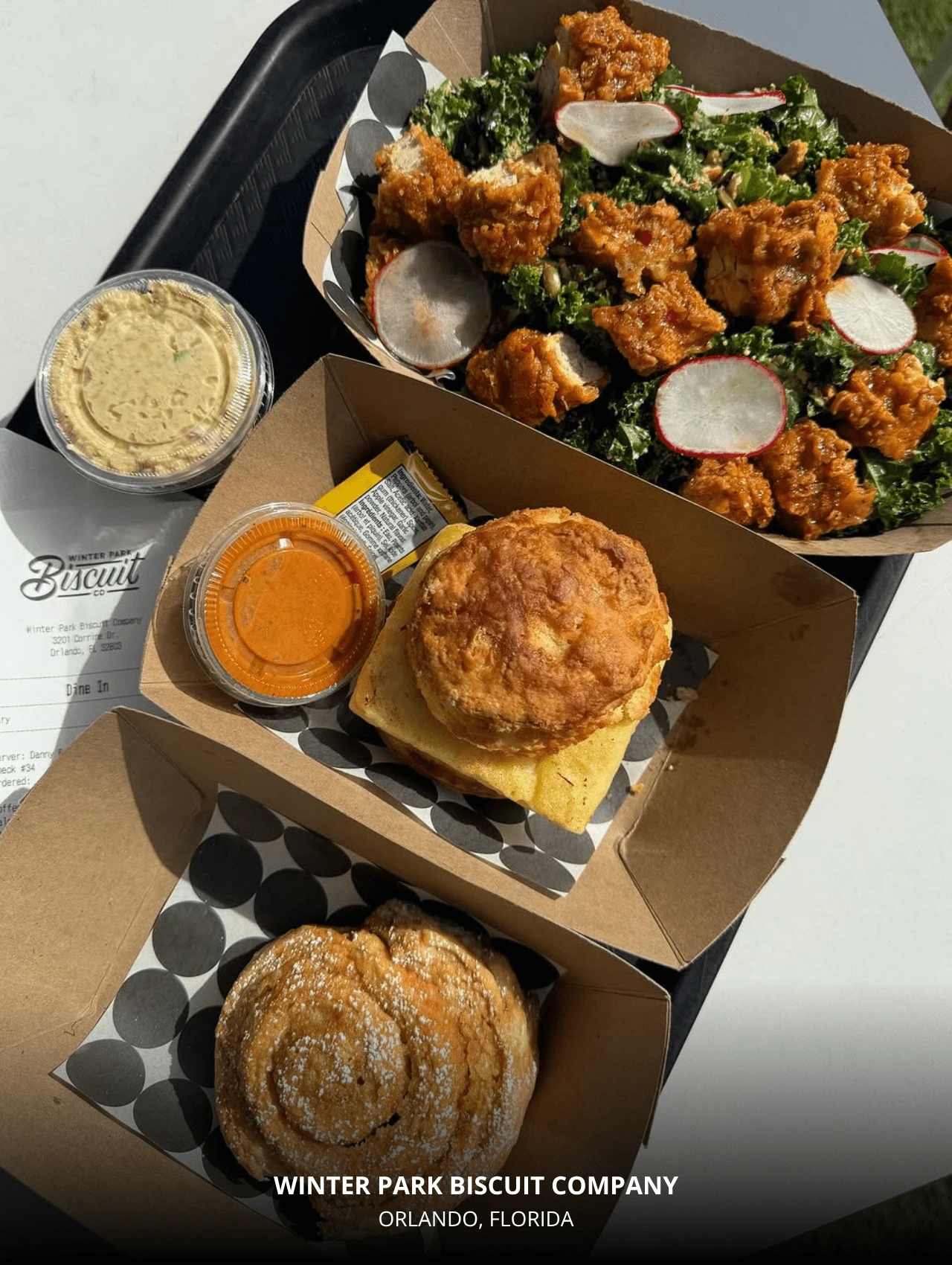 Vegan biscuit sandwich, salad, and cinnamon roll from Winter Park Biscuit Company – best Orlando restaurants.