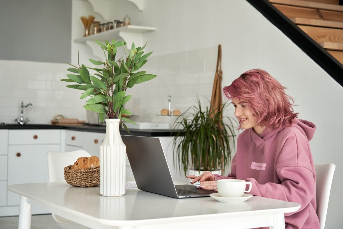 Girl in Pink Hair and Pink Hoodie using Laptop