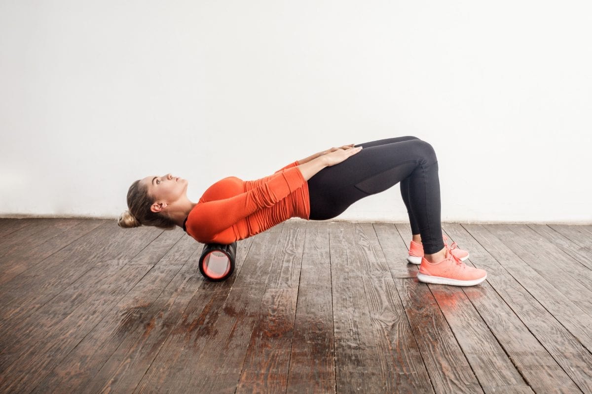 Woman Stretching on Foam Roller