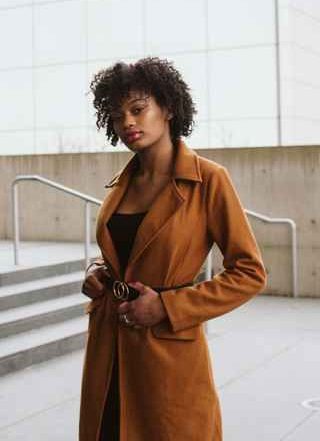 Model using a long and elegant brown coat