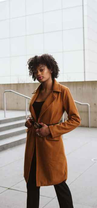 Model using a long and elegant brown coat