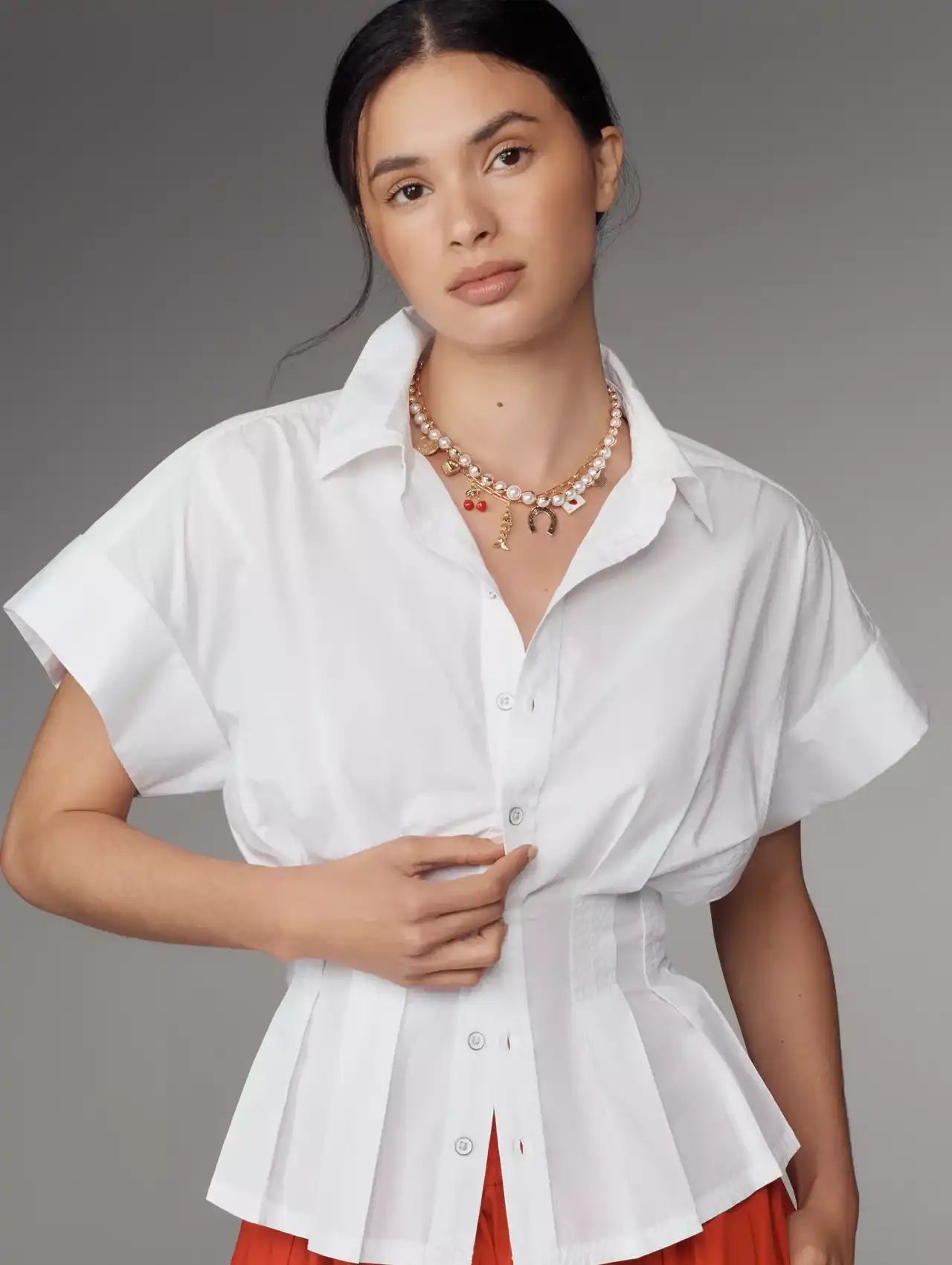 White cotton peplum blouse styled with layered necklace, chic fall tops fashion.