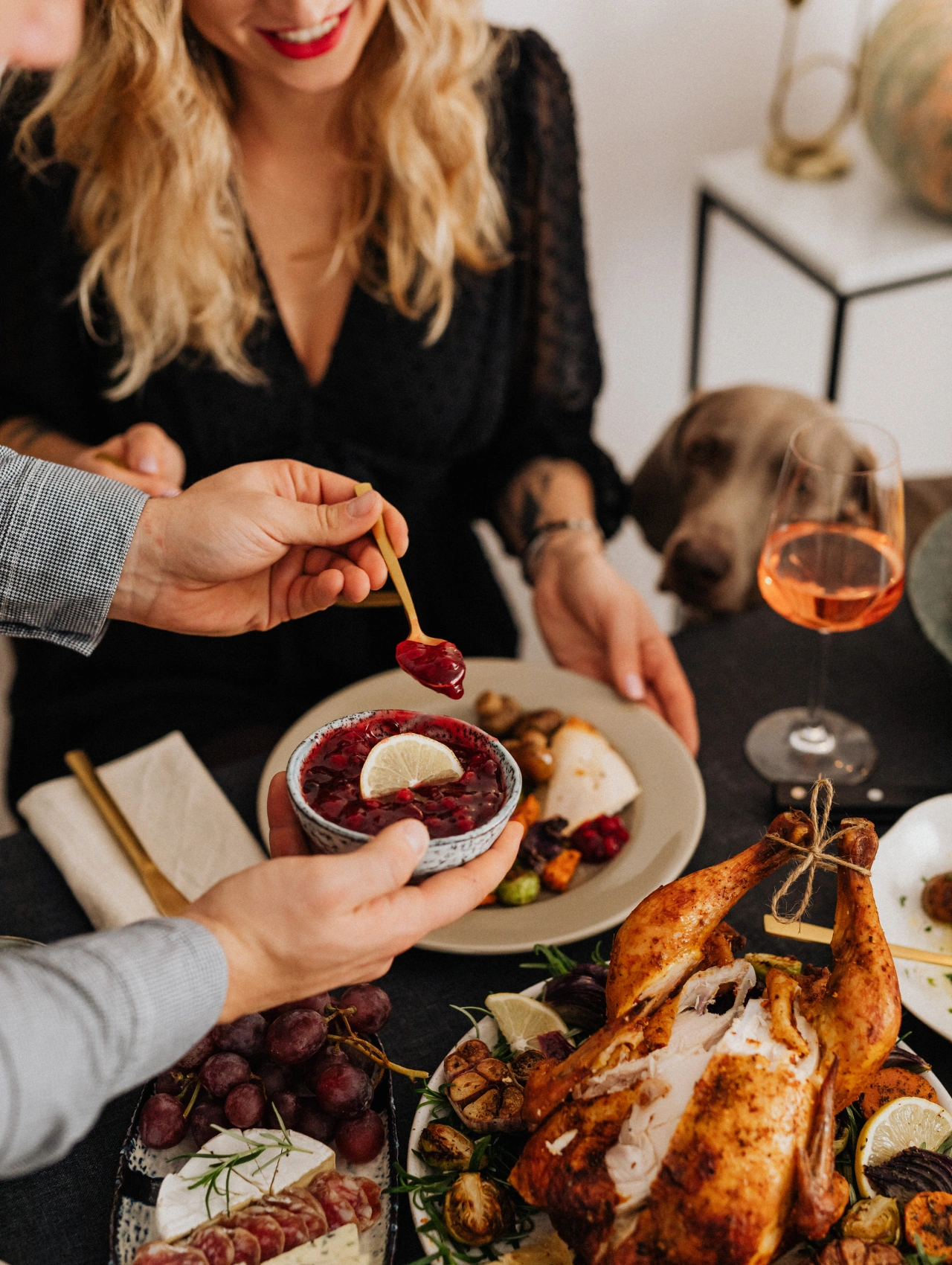 Festive Christmas Dinner spread with roasted chicken, side dishes, cranberry sauce, and a joyful gathering at the table.