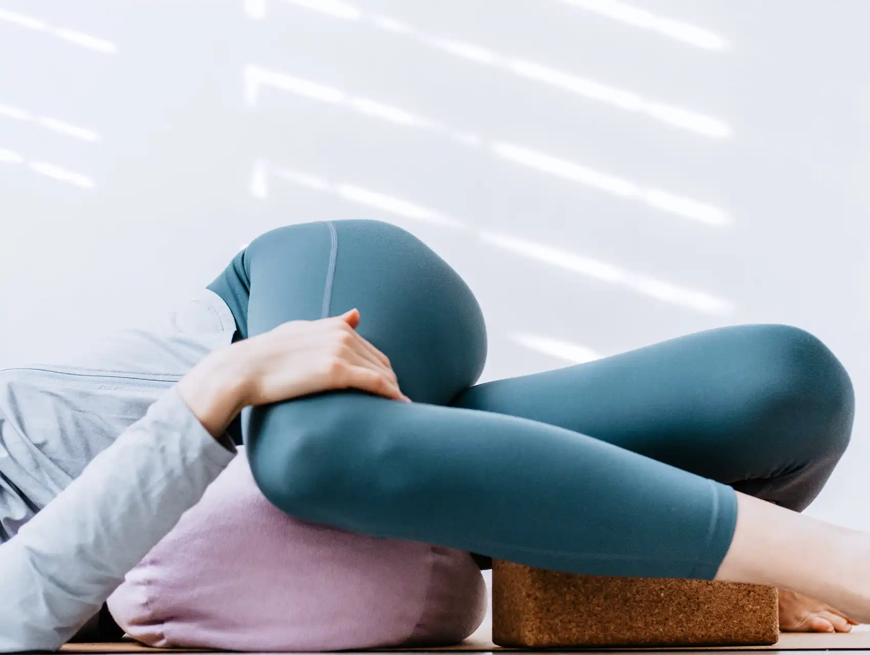 Woman lying on pink bolster in supported yoga twist pose with bolsters

Woman lying on pink bolster in supported yoga twist pose with bolsters