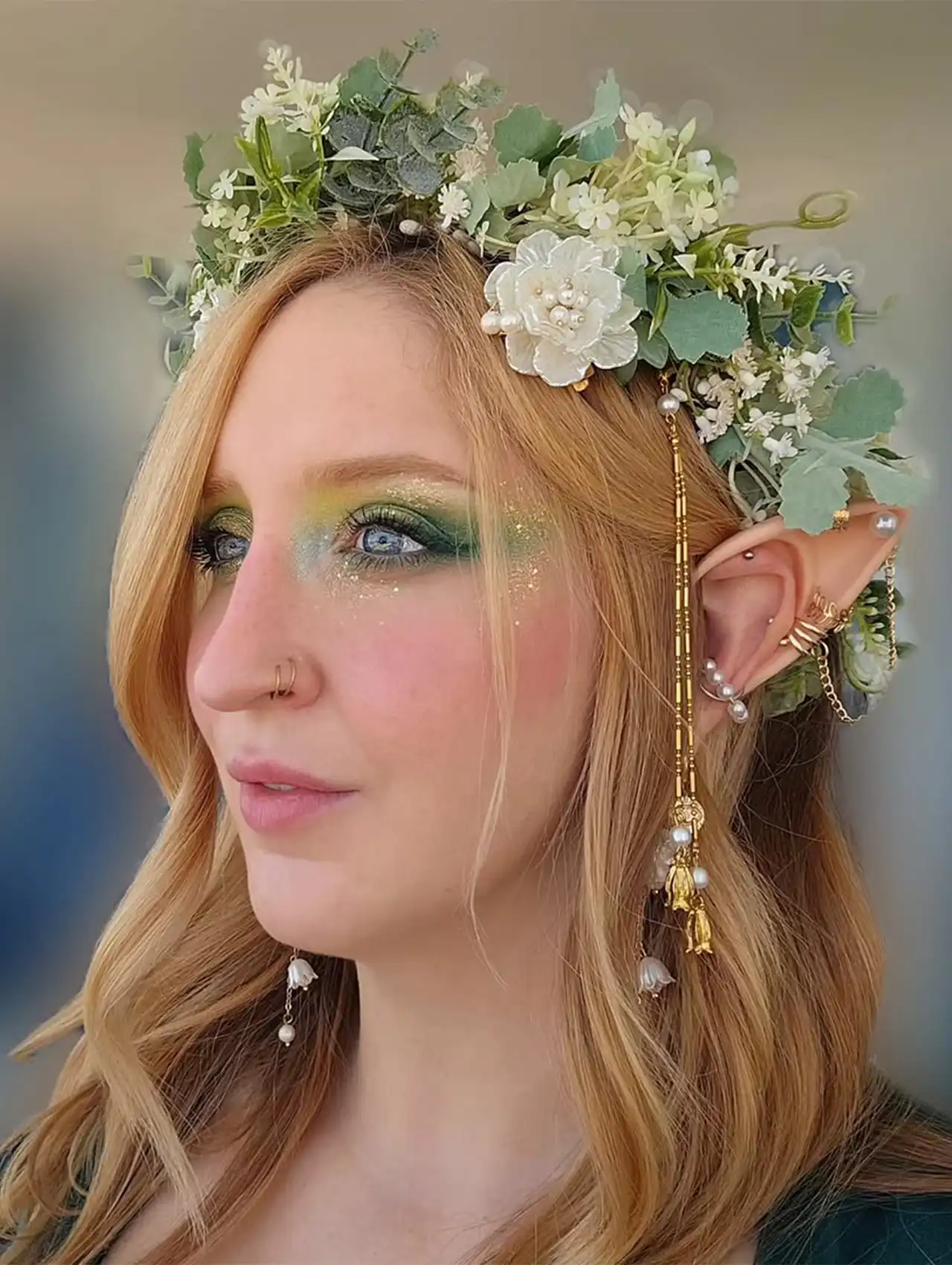 Enchanted halloween makeup looks with elf ears, green glitter eyeshadow, and floral crown.