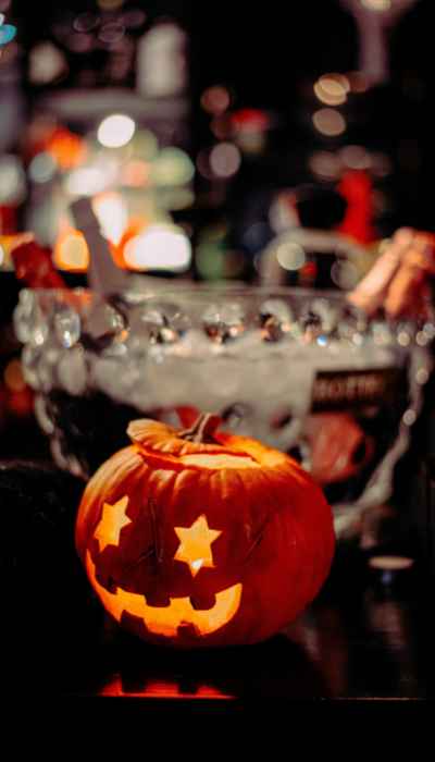 Halloween pumpkin lit up in a bar