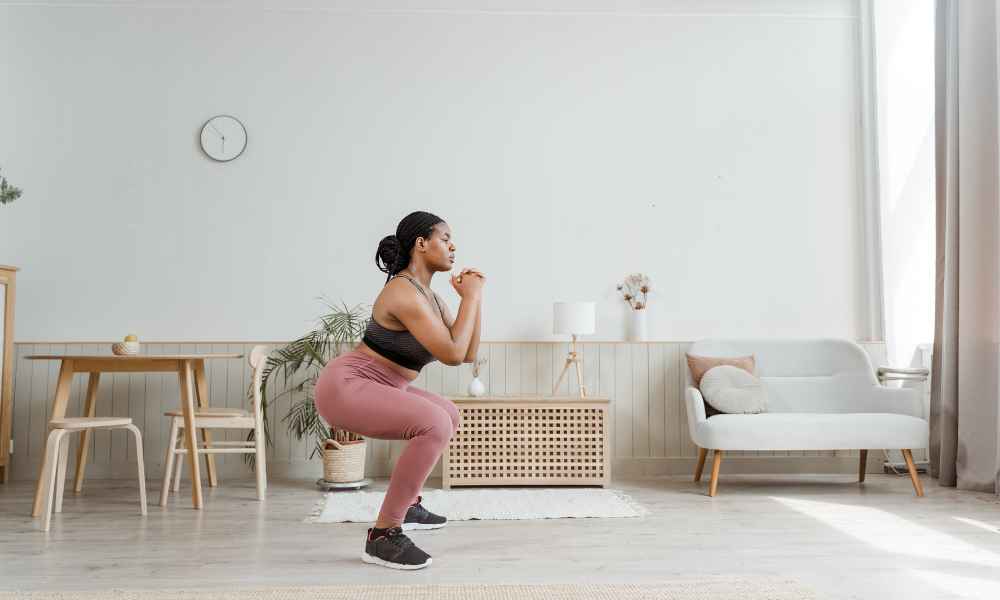Woman doing the second step of a squat