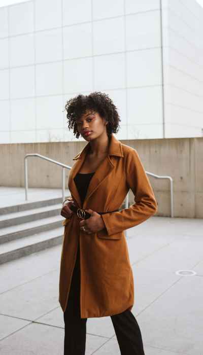 Model with a terracotta long coat
