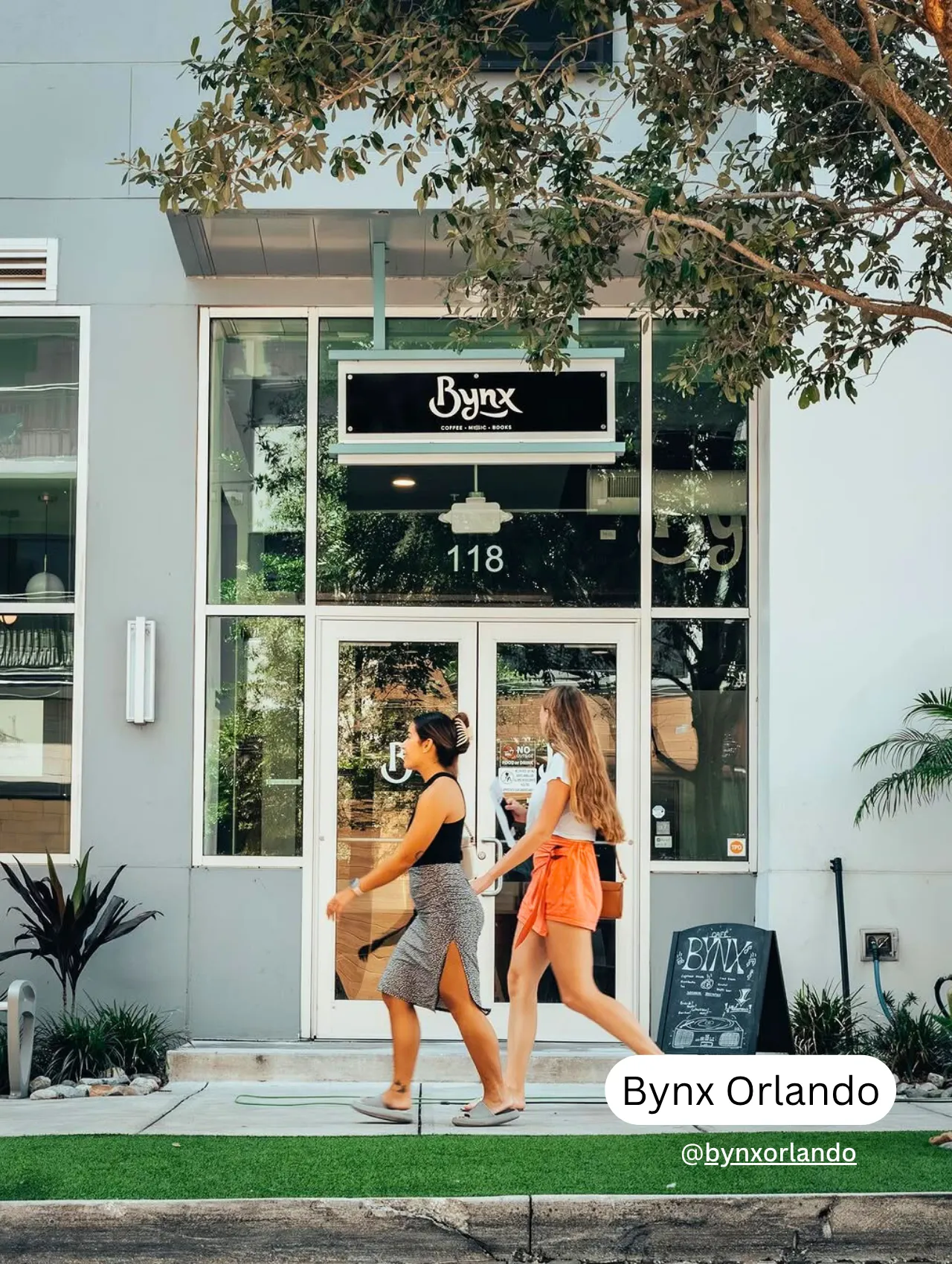 Entrance of Bynx Orlando coffee shop with modern storefront and pedestrians in view – one of the best coffee shops in Orlando.