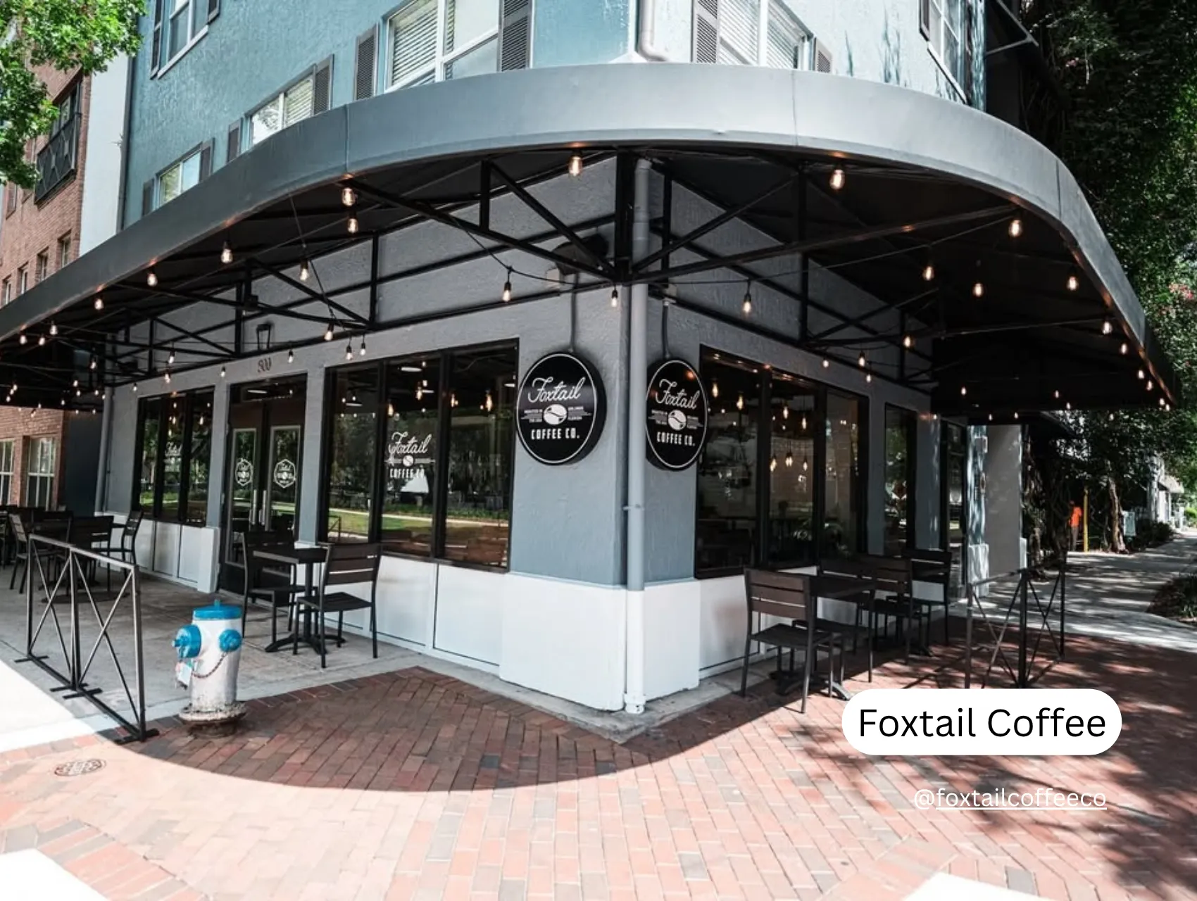 best coffee shops in orlando with outdoor seating in Orlando featuring modern black chairs and overhead string lights.