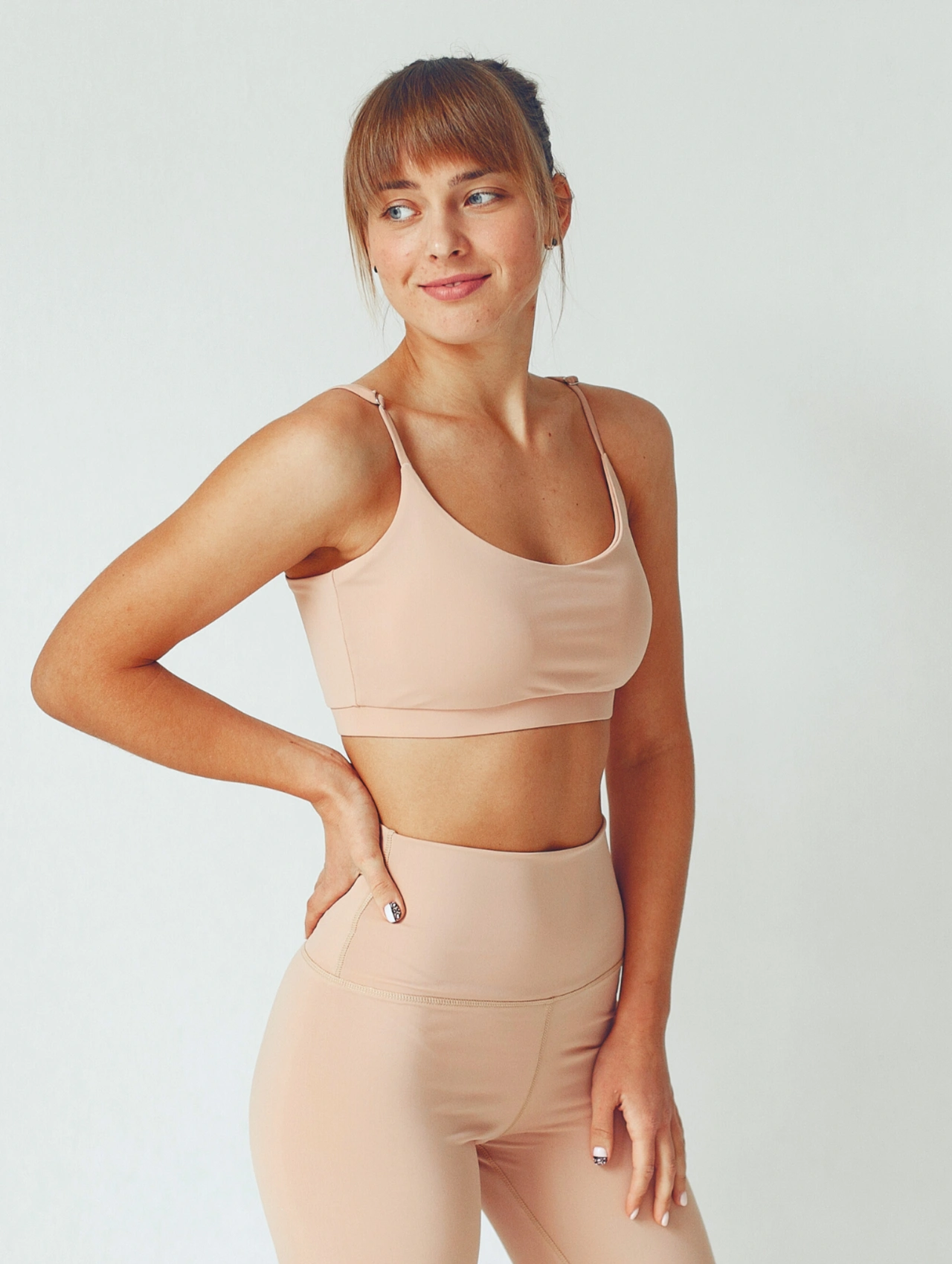 Setting up a 30 day ab challenge routine with a woman in activewear standing confidently before a workout.