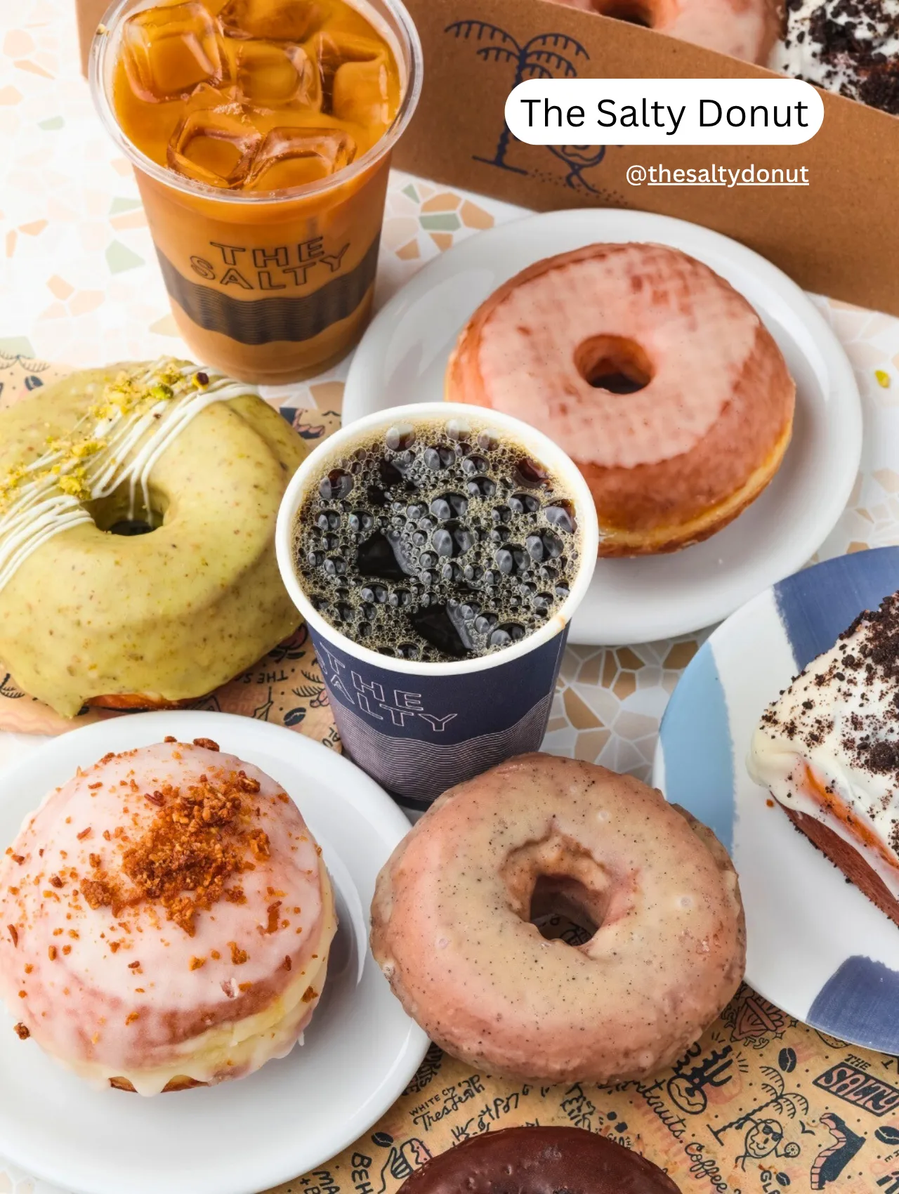 Colorful display of donuts and iced coffee from The Salty Donut in Orlando – trendy spot for coffee lovers.