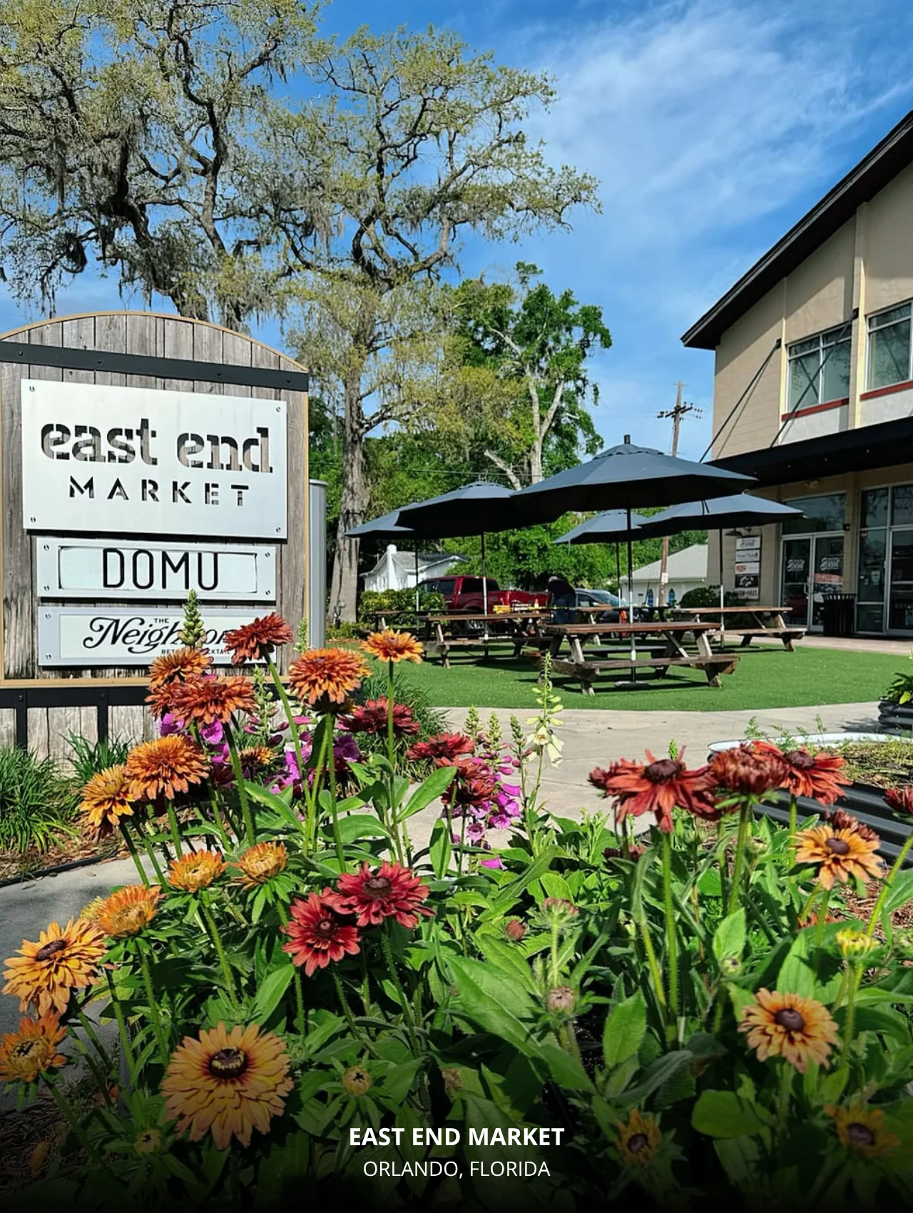 Top Locations In Orlando To Take Beautiful Photos For Your Instagram – East End Market entrance surrounded by vibrant flowers.