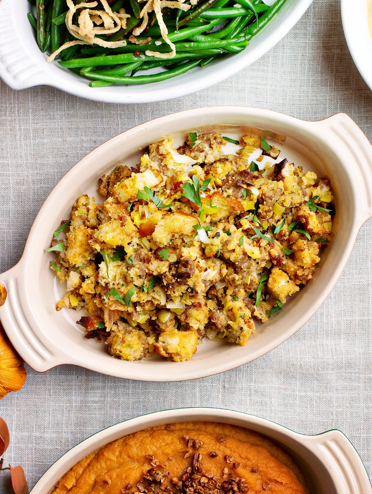 Homemade vegan stuffing and sides served in dishes, essential recipes for a Thanksgiving Menu.