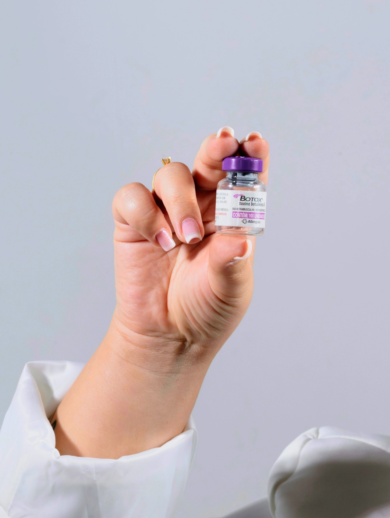 A hand holding a small vial of Botox, one of the most popular beauty treatments in Orlando for 2025.