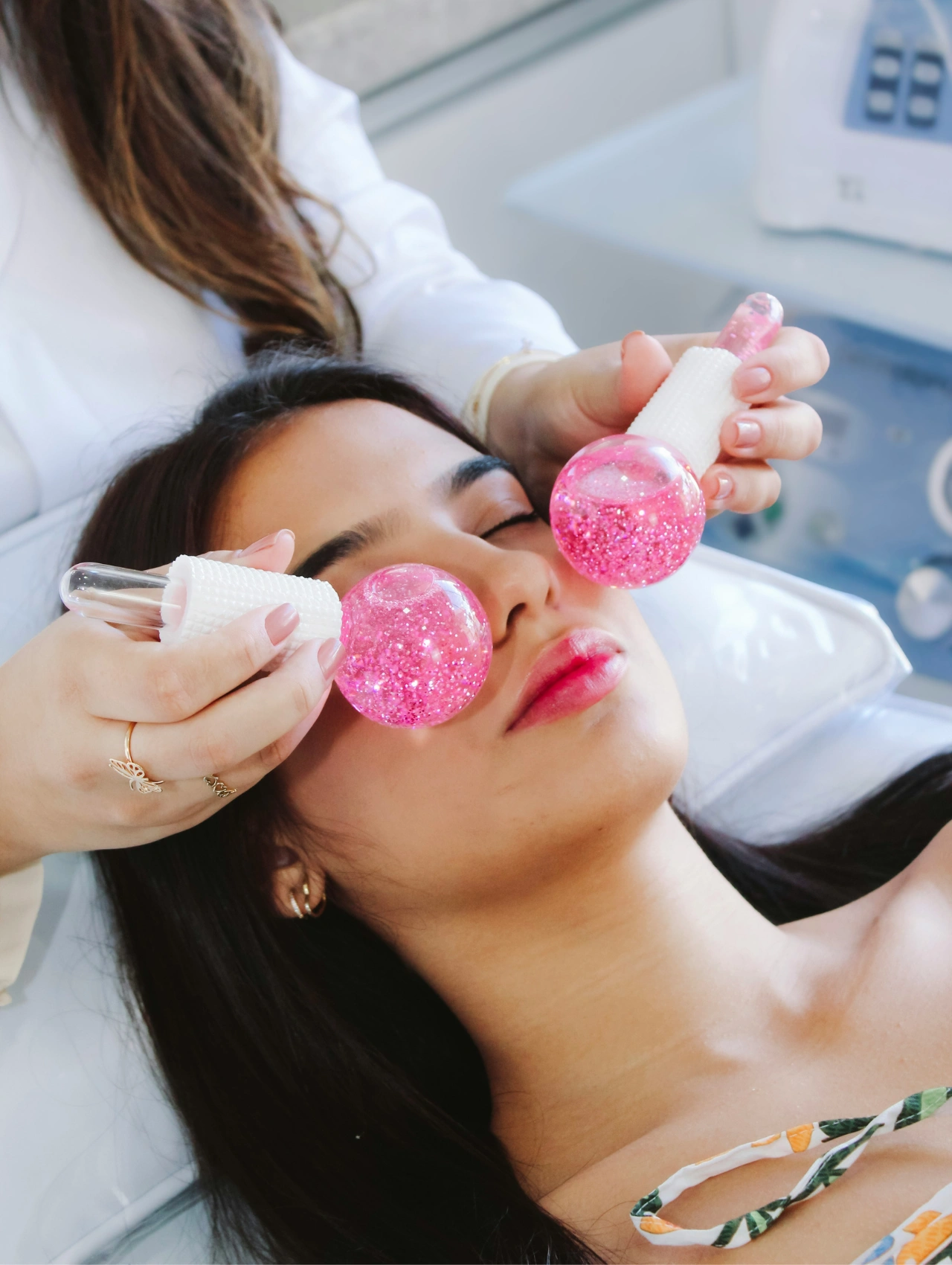 Woman receiving a relaxing facial with glittery cryo globes, a trending beauty treatment in Orlando.
