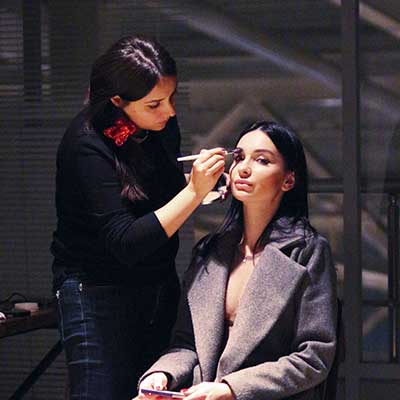 Makeup expert doing makeup on a client.
