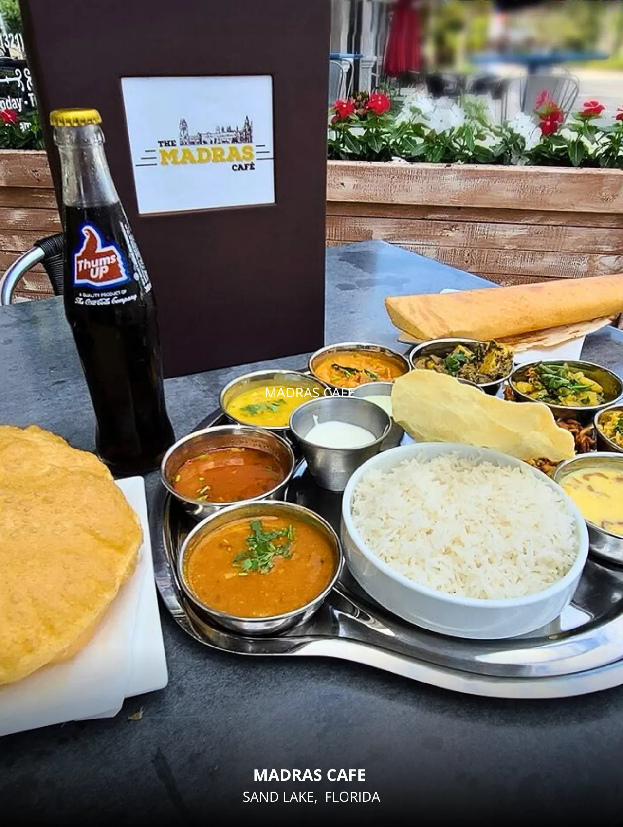 A vibrant thali meal at Madras Cafe featuring rice, curries, and naan, one of the best restaurants in Orlando for flavorful vegetarian Indian cuisine.