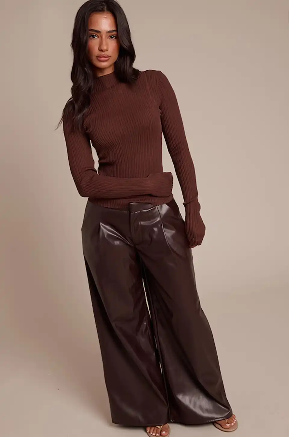 Model wearing wide-leg brown faux leather pants with a fitted brown sweater.