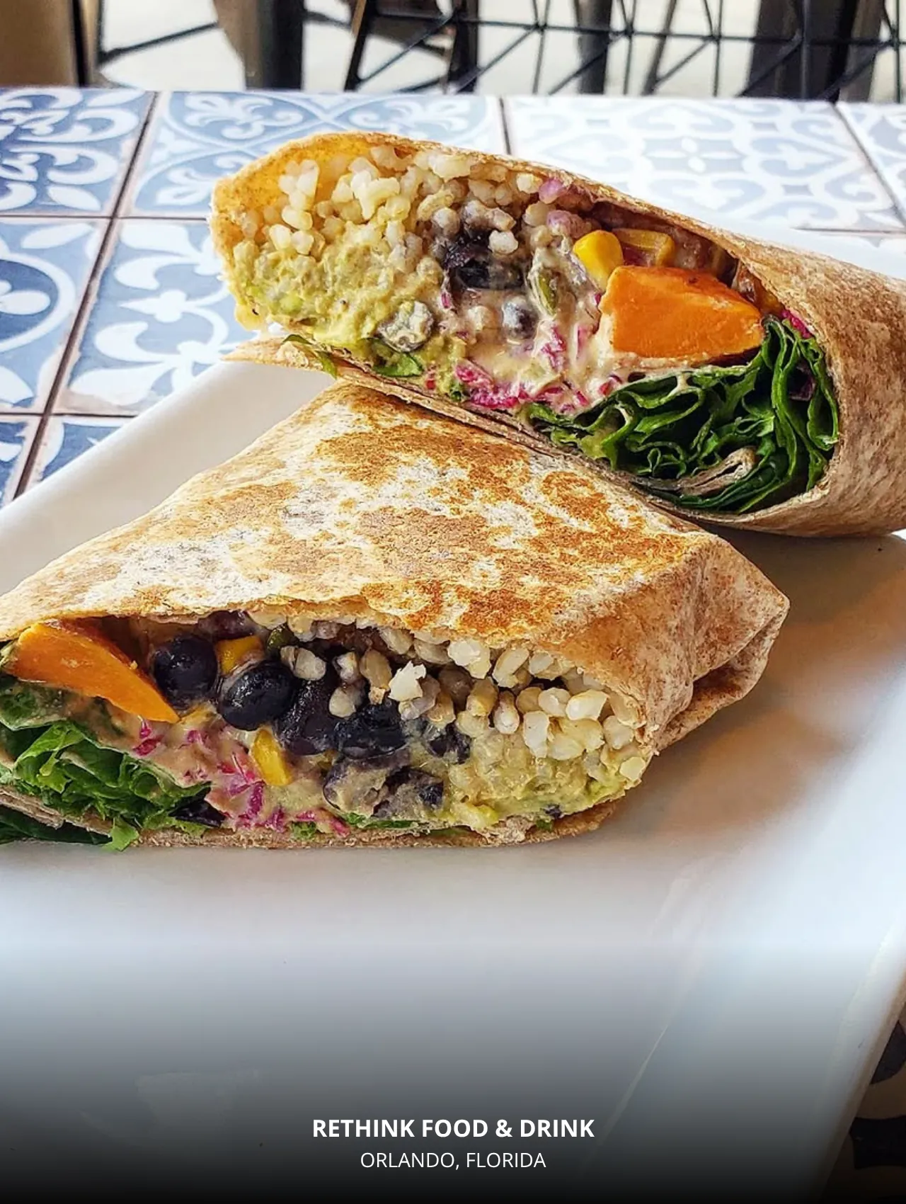 Plant-packed wrap cut open at Rethink Food & Drink, a best restaurants in Orlando vegan pick.