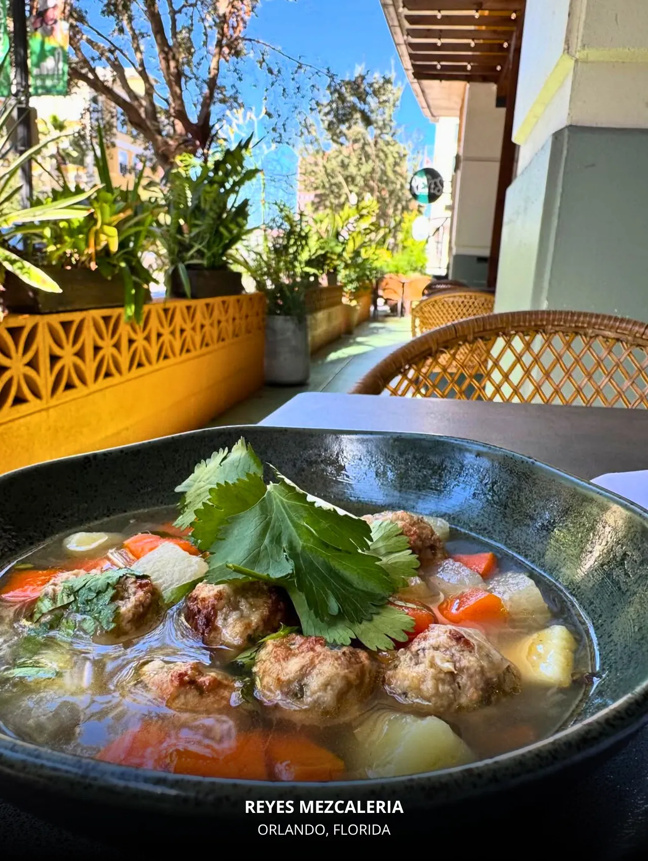 Hearty albóndigas soup on the patio at Reyes Mezcaleria – best restaurants in Orlando list.