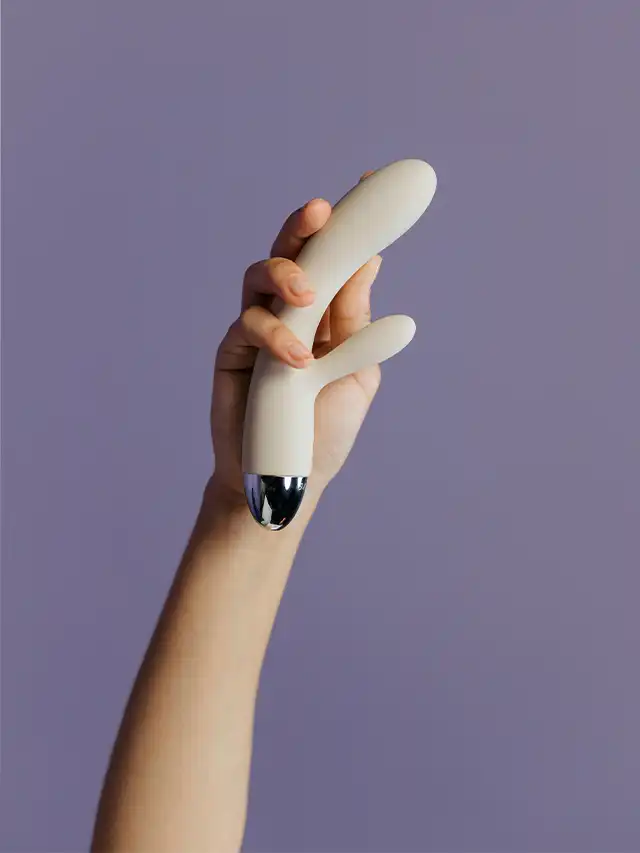 a hand holding a white object