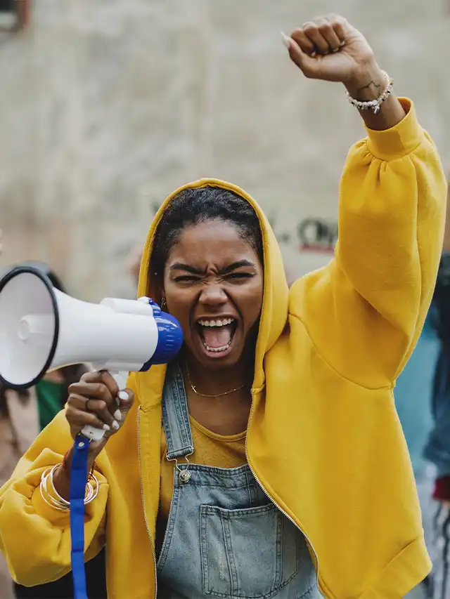 a woman yelling into a megaphone