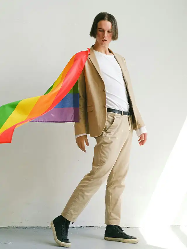 a man in a suit with a rainbow flag