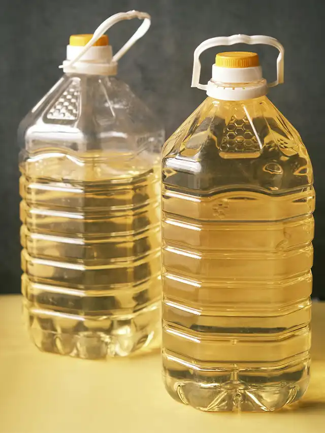 two plastic bottles with yellow liquid