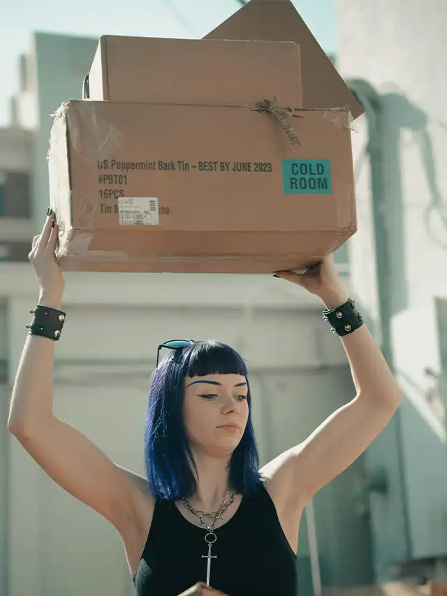 a woman holding a box over her head