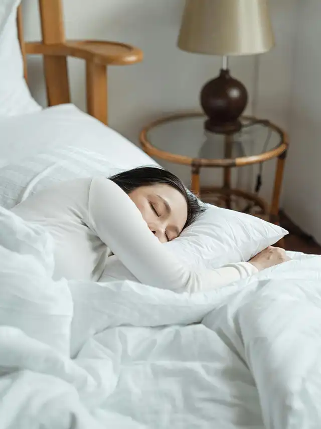 a woman sleeping in bed