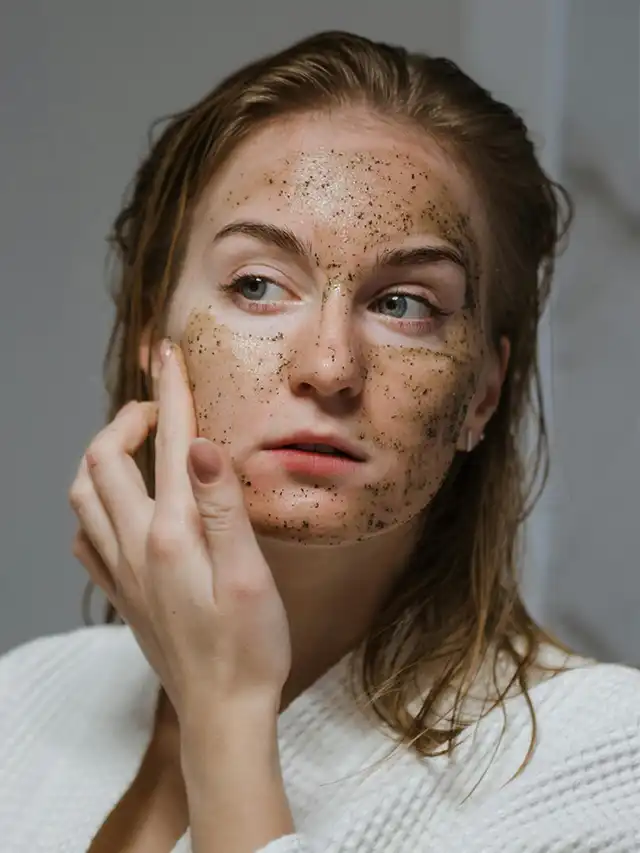 a woman with brown scrub on her face