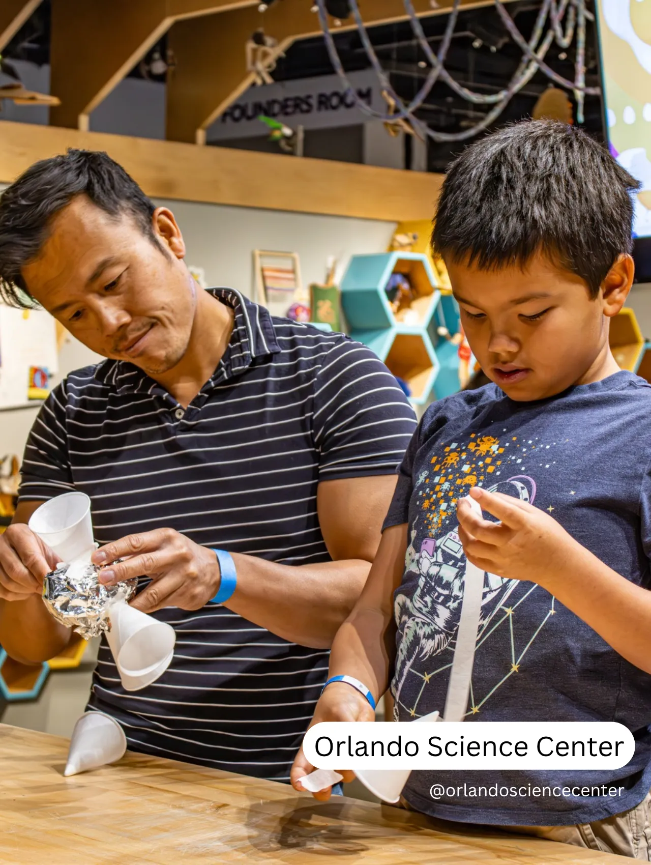 Father and son creating a science project at the Orlando Science Center, one of the top things to do in Orlando besides the theme parks.