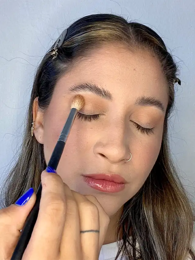 a woman applying makeup on her face