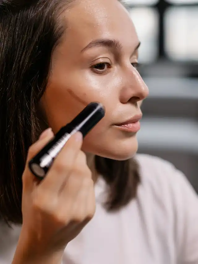 a woman applying makeup