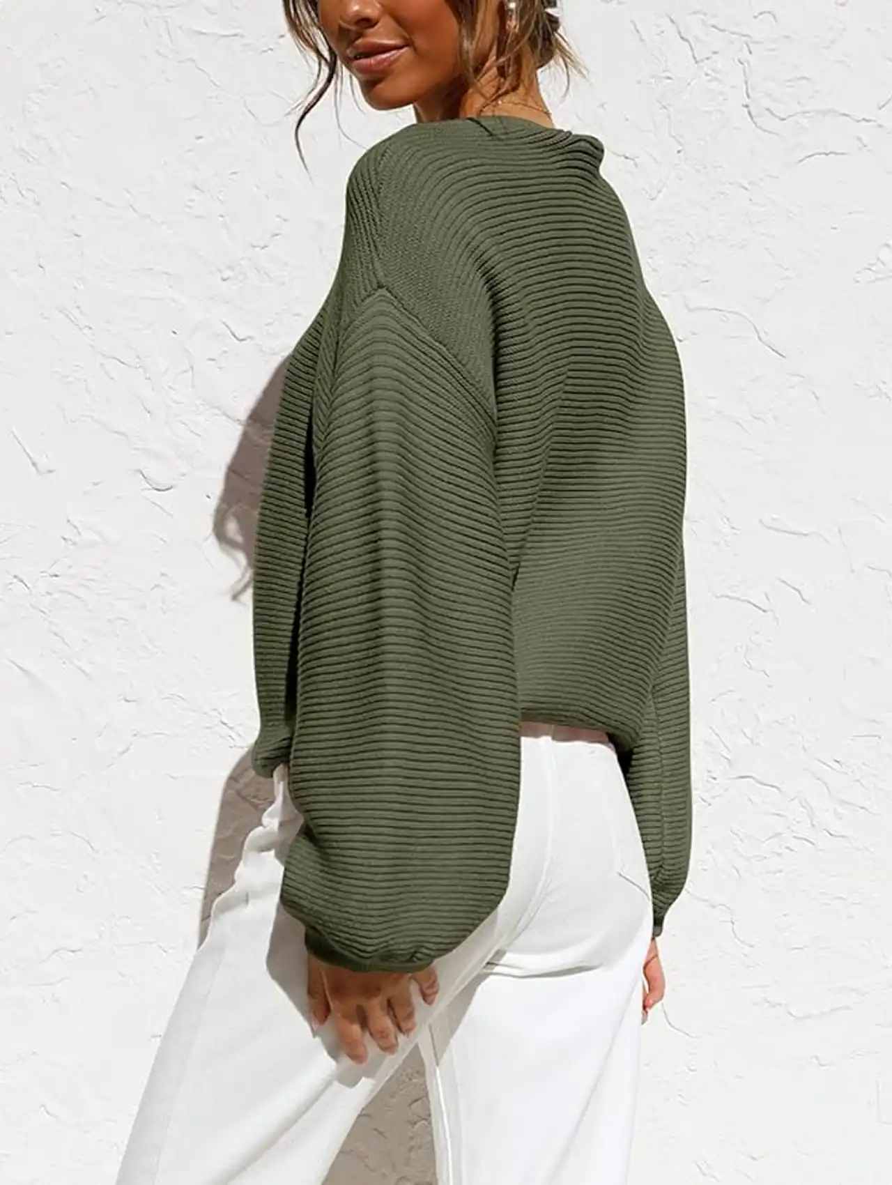 Woman in olive green crewneck pullover sweater with balloon sleeves, fall clothing for women