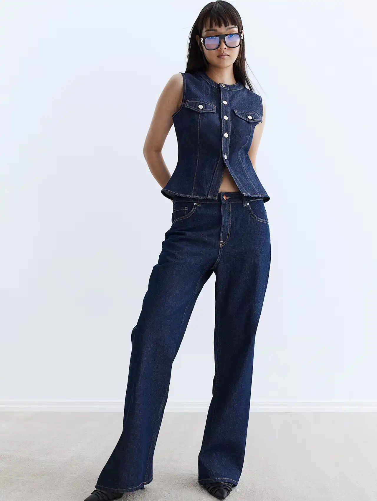 Woman in indigo wide leg jeans with matching denim vest, fall clothing for women