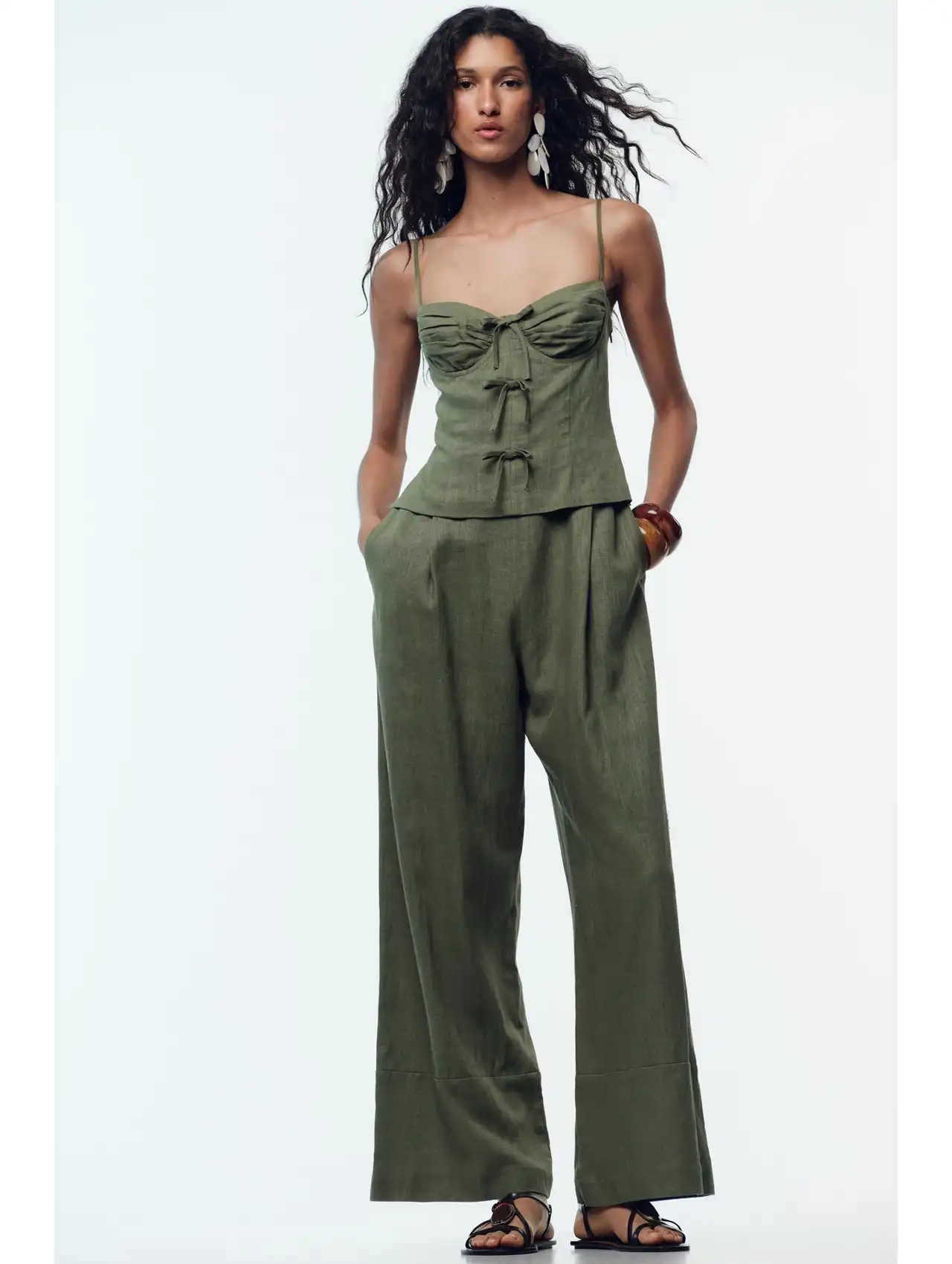 Woman in olive green linen bow strap jumpsuit, fall clothing for women