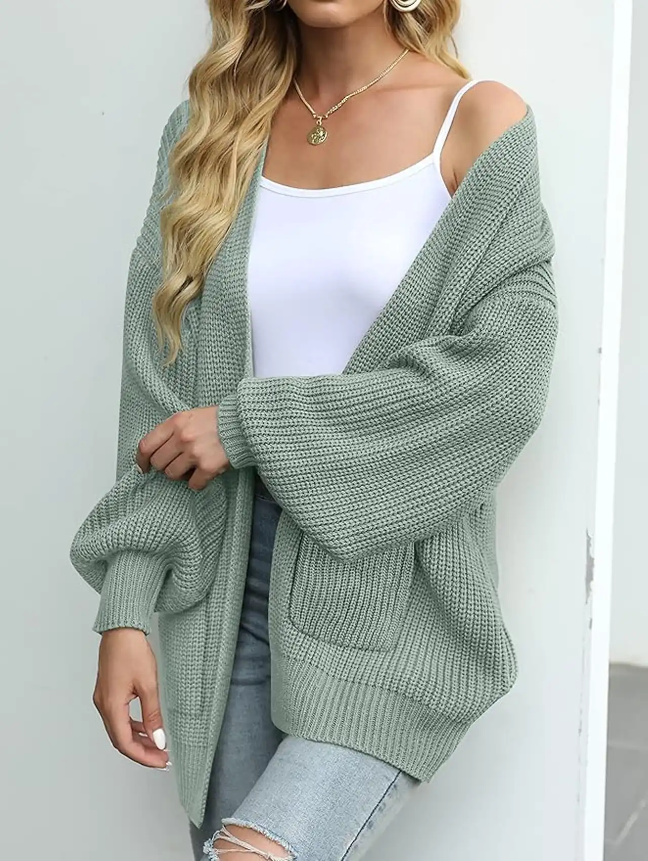 Woman wearing sage green open front knit cardigan with white tank and jeans, fall clothing for women