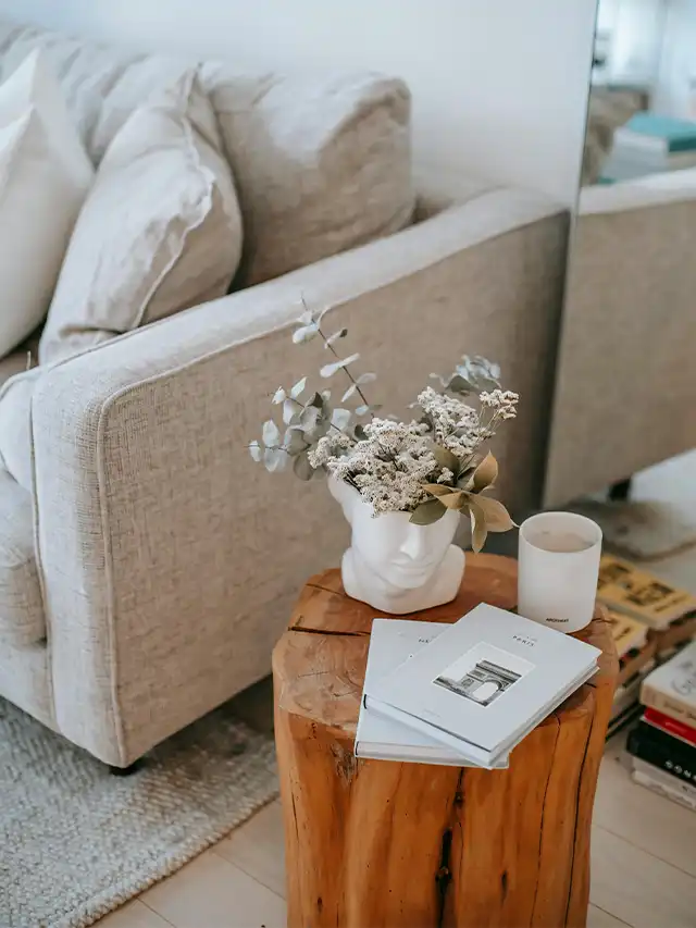 a table with a vase of flowers and a candle on it