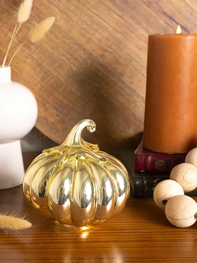 a gold pumpkin on a table