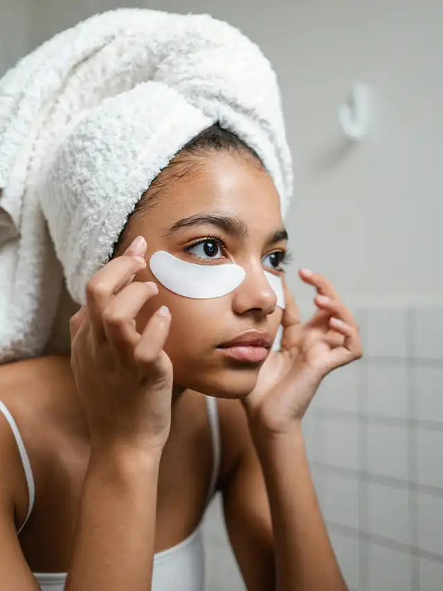 a woman with a towel on her head and eye patches